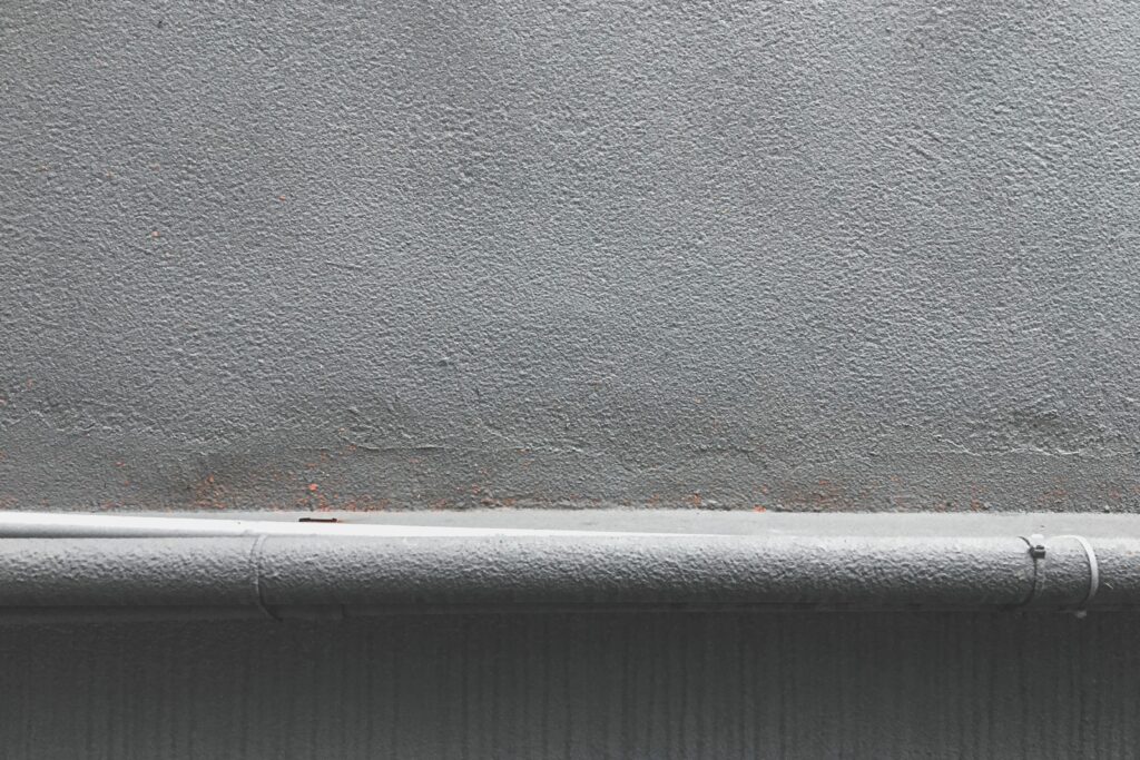 Close-up of a cracked concrete surface being prepared for repair