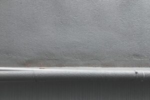 Close-up of a cracked concrete surface being prepared for repair
