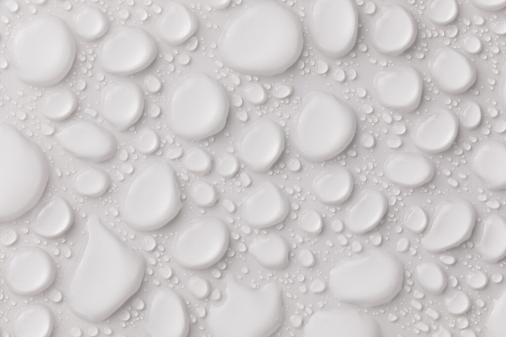 Wet bathroom floor tiles showing the surface that needs waterproofing before tiling